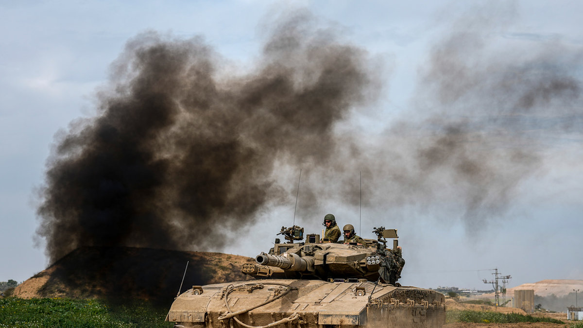 Israeliska soldater kör en stridsvagn nära gränsen till Gazaremsan på tisdagen.