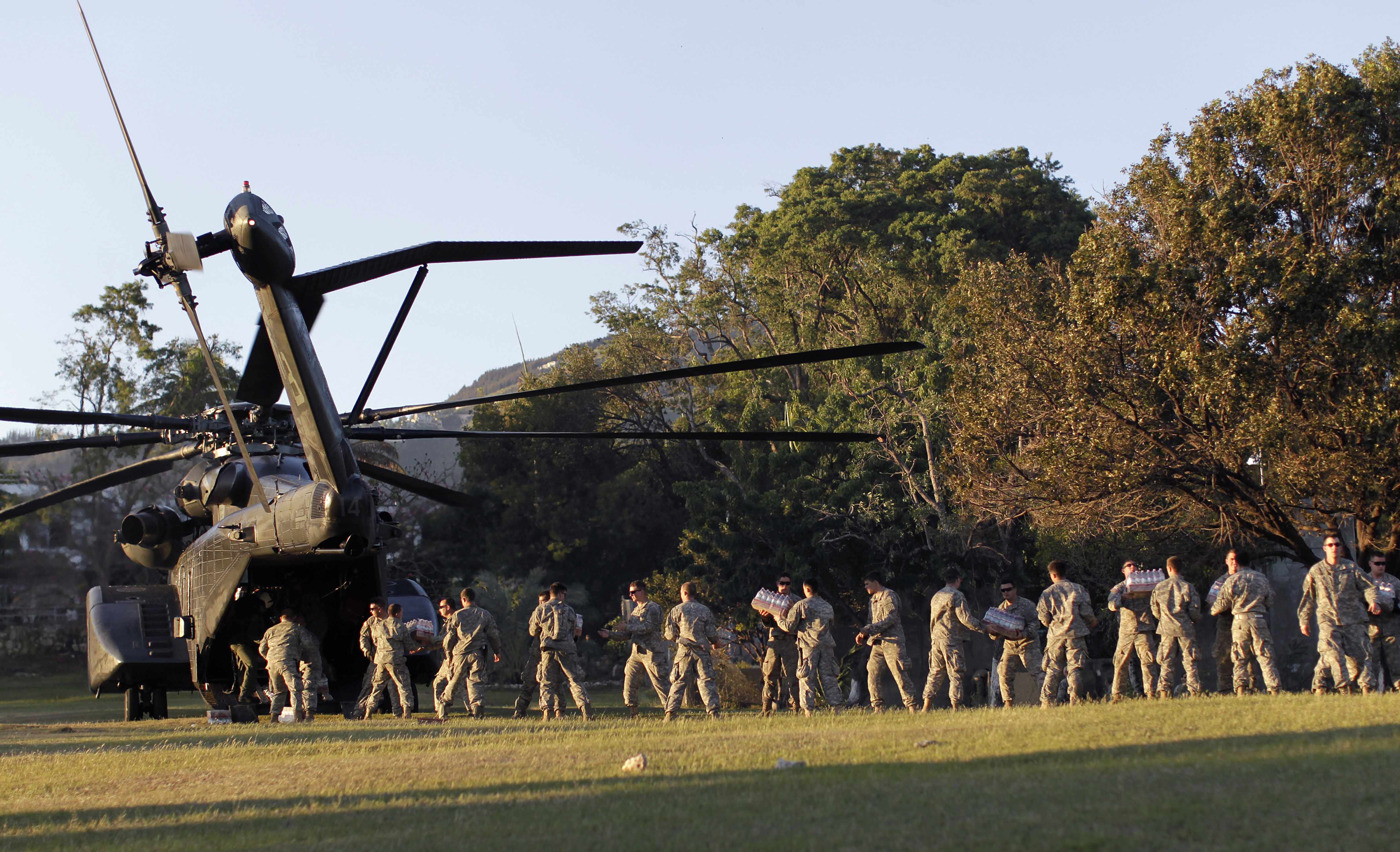 Amerikanska marinsoldater bildar kedja för att distribuera hjälpsändningar till nödställda haitier.