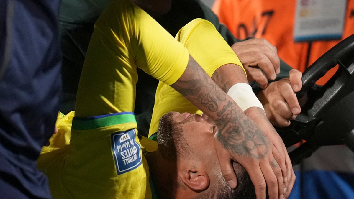 Brasiliens Neymar körs av planen efter att ha skadat knäet under VM-kvalmatchen mot Uruguay i Montevideo.