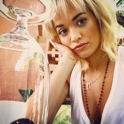 Rita Ora umgås med ett glas. Rita Ora umgås med ett glas.