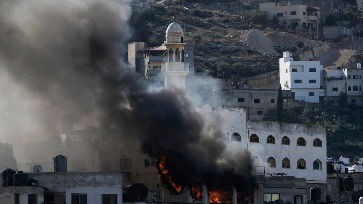 Byggnader i brand under en israelisk militärinsats i Jenin på Västbanken i december i fjol. Arkivbild.