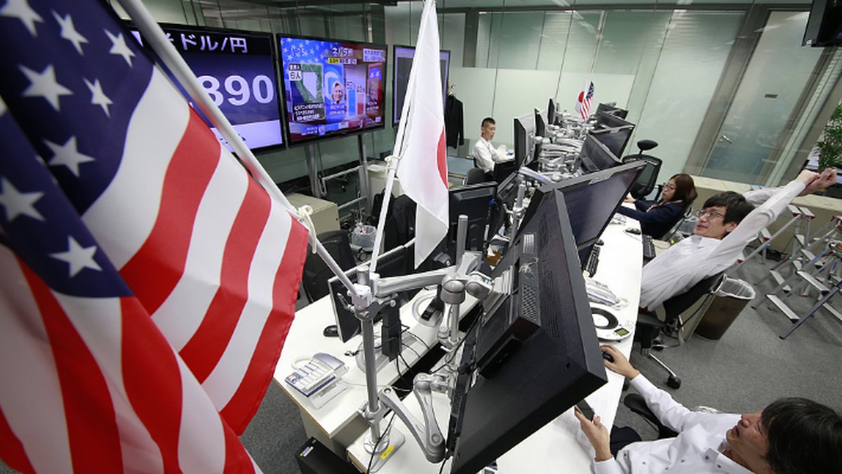 Börsmäklare bevakar skärmarna för att få koll på läget över börsen i Tokyo efter presidentvalet.