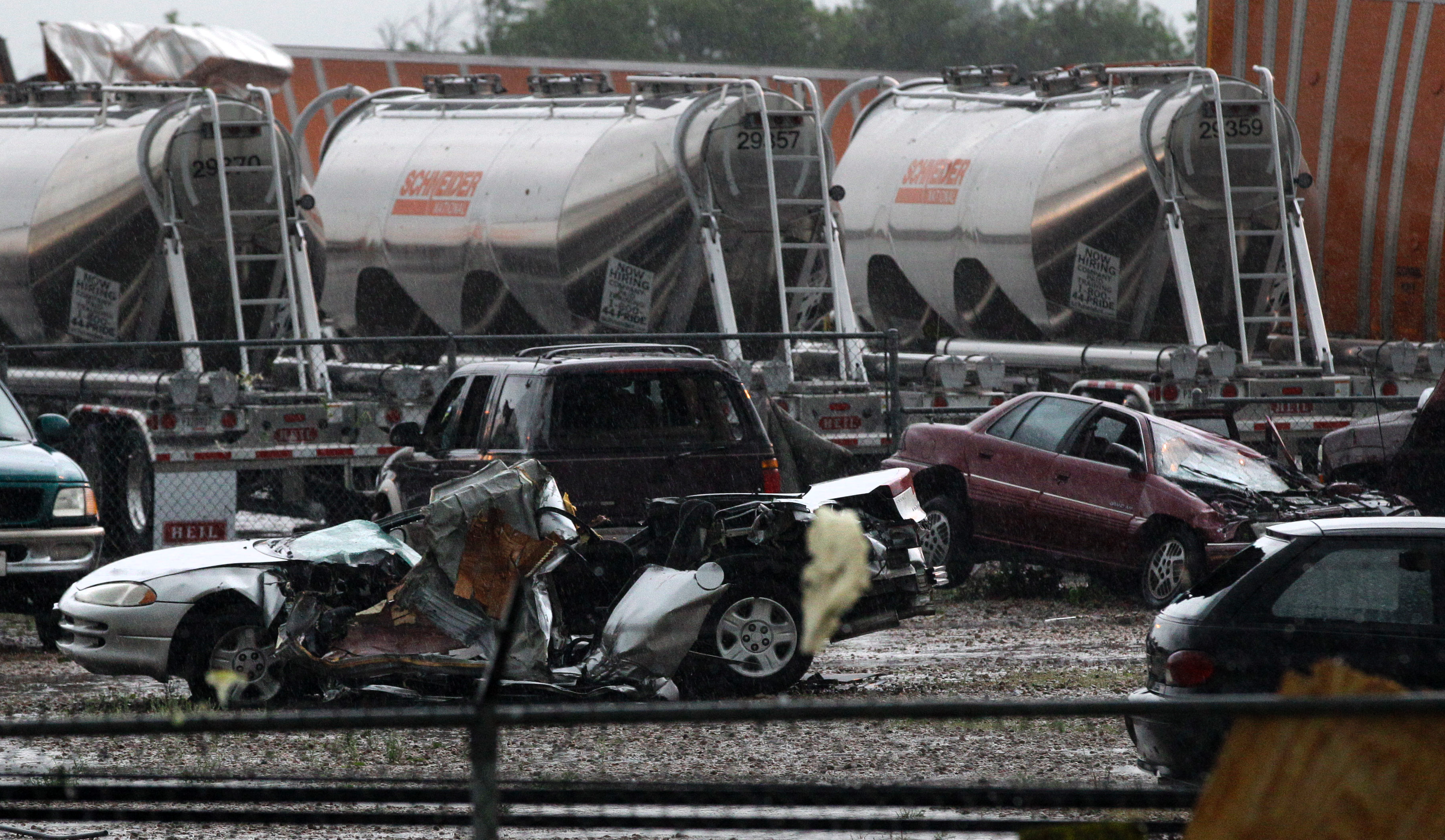 Stora traktorer med släp kastades upp i luften när en tornado drog fram genom ett transportföretag i Dallas.