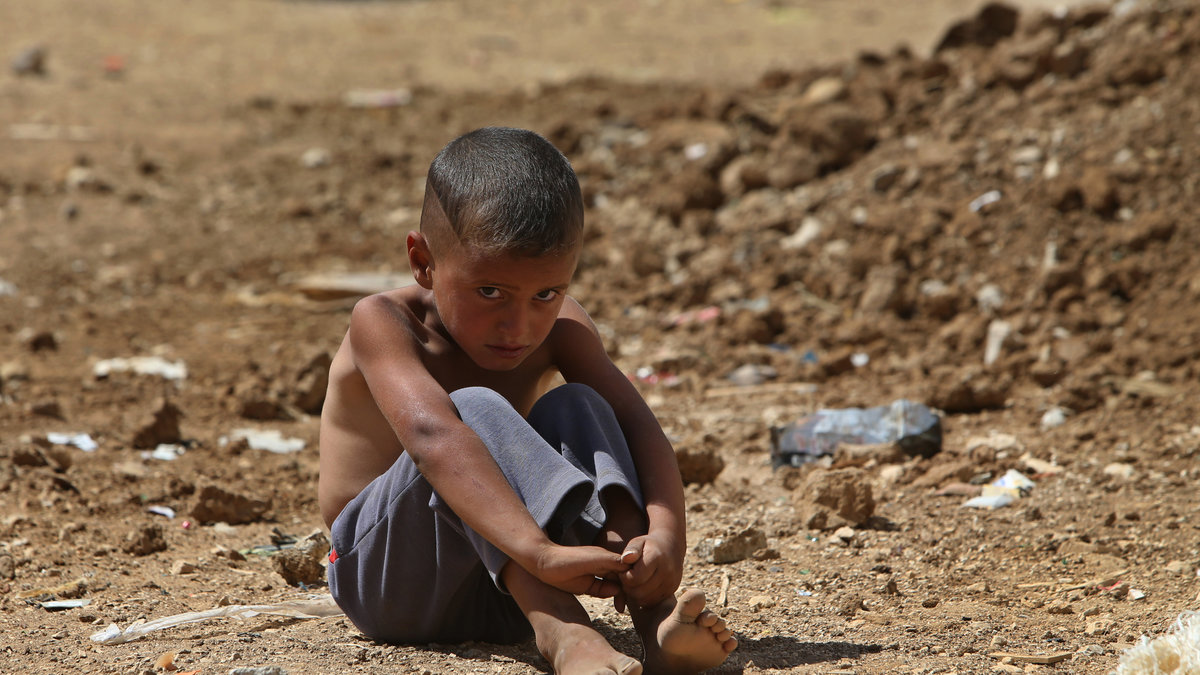 En pojke sitter vid ett tillfälligt flyktingläger i Libanon, september 2013. 