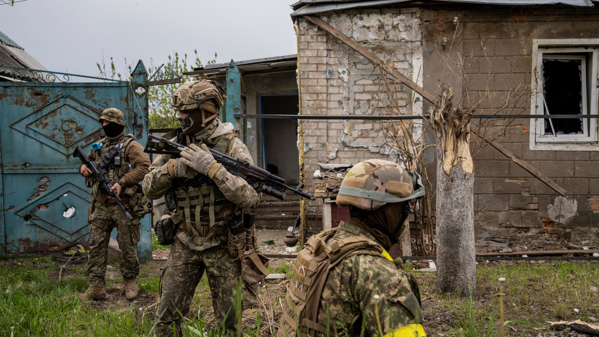 Ukrainska soldater undersöker en återtagen by i Charkivregionen i nordöstra Ukraina.