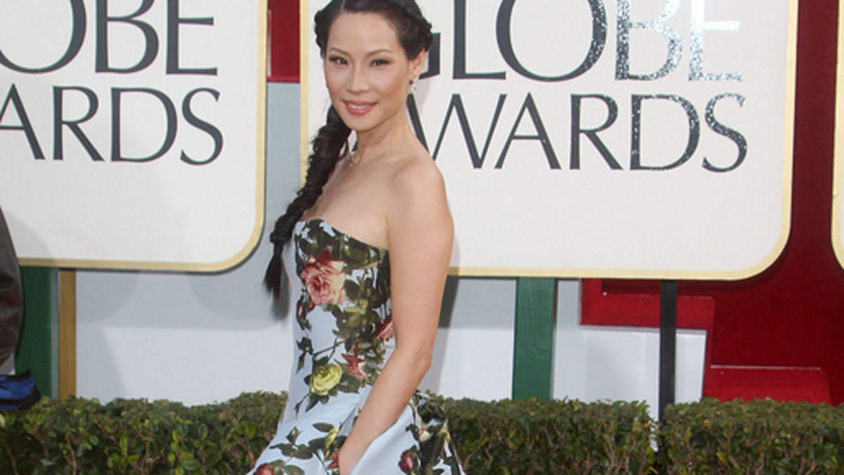 Lucy Liu virade in sig i en tapetrulle.
