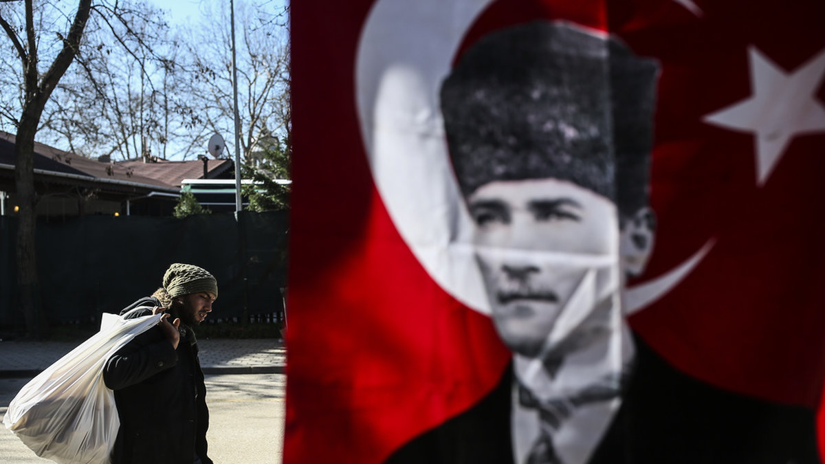 Migrant passerar bild på moderna Turkiets grundare Kemal Atatürk i Edirneregionen, nära Grekland. Arkivbild.